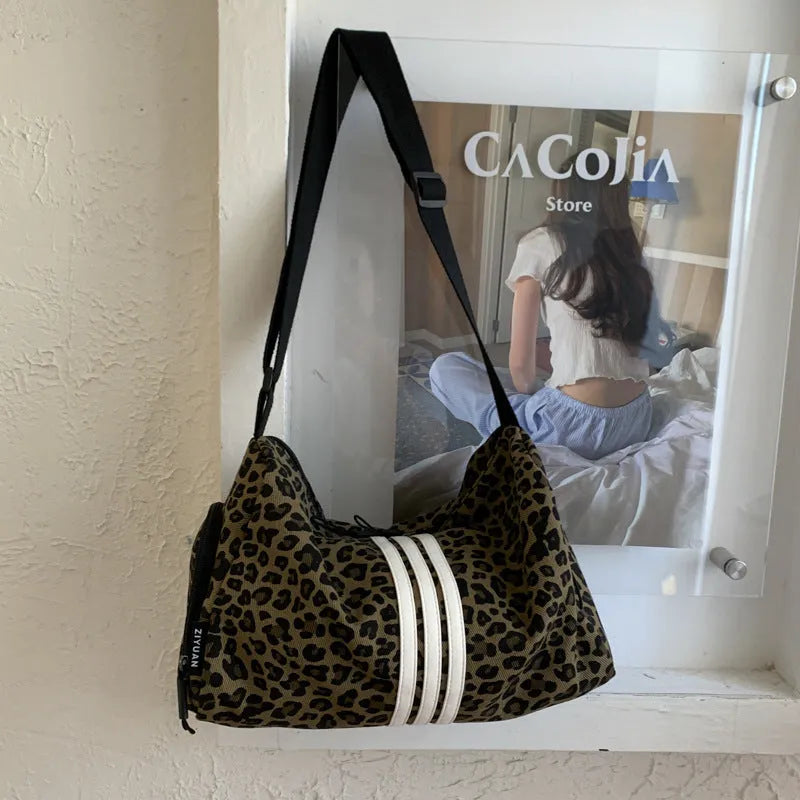 Leopard print sports style shoulder messenger bag with cross-body strap and stitching details