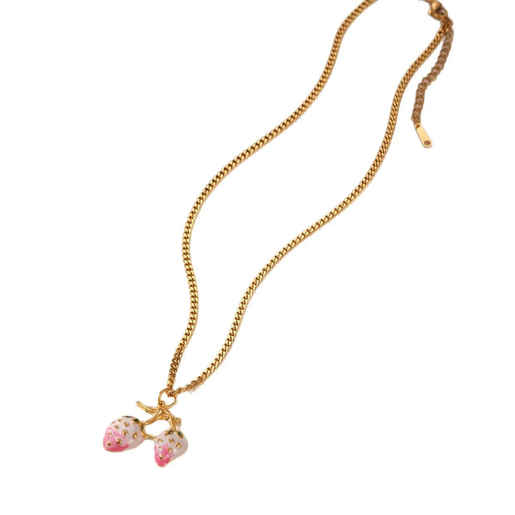 Close-up of a red stainless steel strawberry charm necklace on an alloy chain.