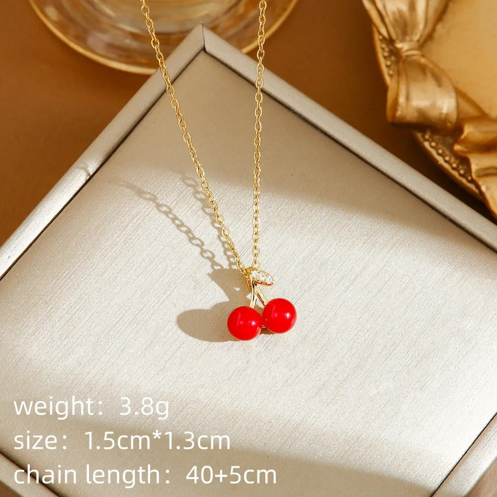 Delicate indie women's necklace with cherry, strawberry and pepper charms on a titanium steel O-ring chain.