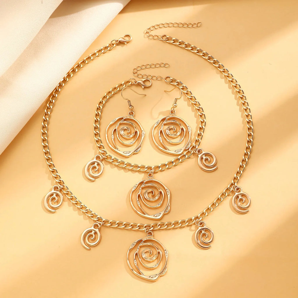Women's spiral donut jewellery set showing matching necklace, bracelet and ear hooks in gold or silver electroplated alloy