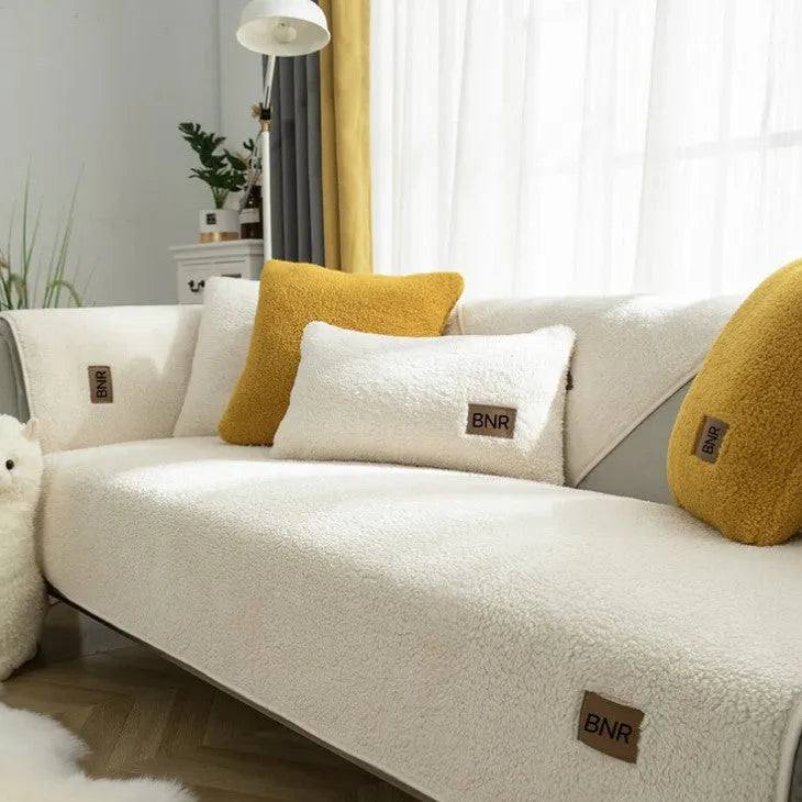 Lambswool solid colour sofa cover in blue, shown on a three-seater sofa.