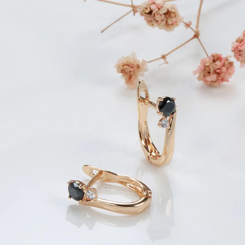 Gold geometric drop shape earrings with retro design and stone inlay on copper.