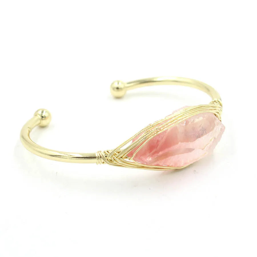 Raw gemstone winding bracelet with 8mm amorphous crystal beads in various colours on a white background.