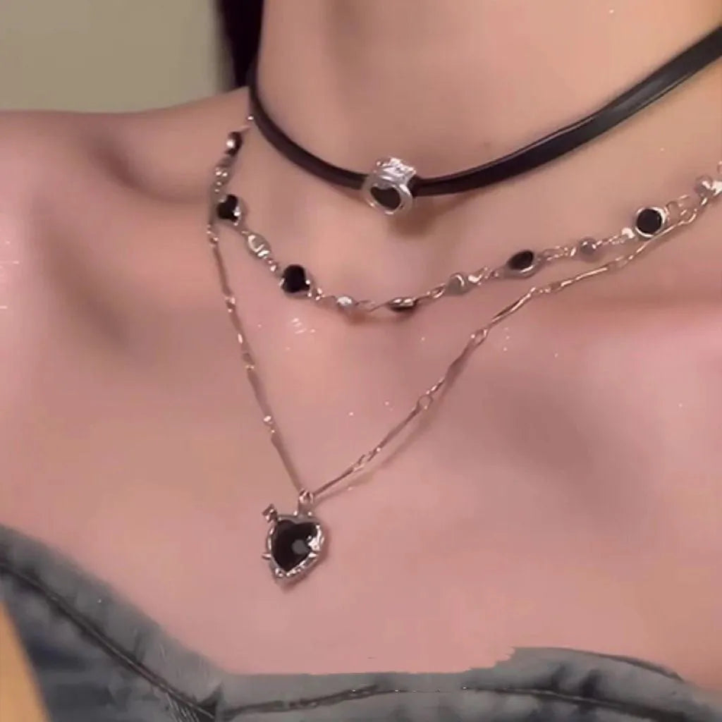 Women's twin necklace set with alloy heart pendants, artificial crystal details, and leather elements on clavicle chains