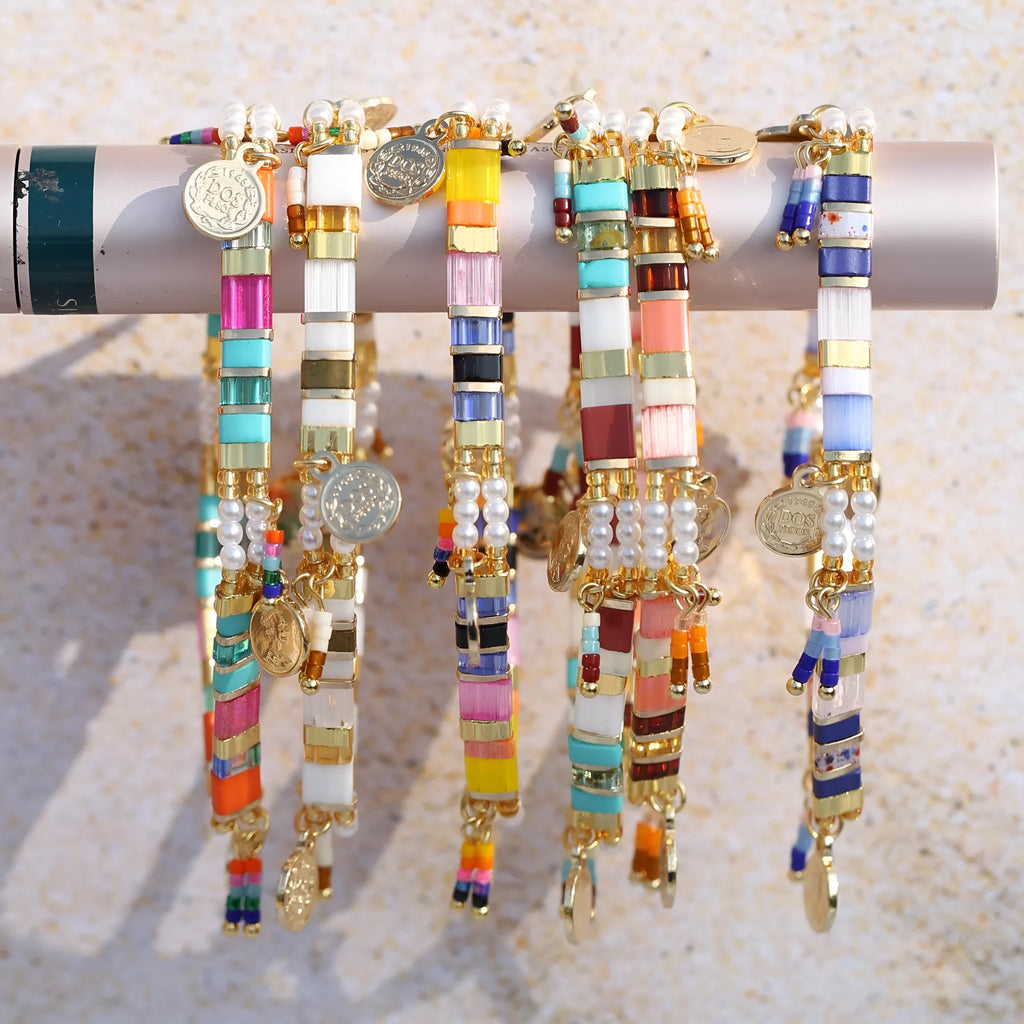 Women's imitation pearl and glass beaded bracelet showing six different colour variations with adjustable closure