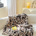 Thick striped chenille handmade blanket in a choice of four colours, shown on a double bed.