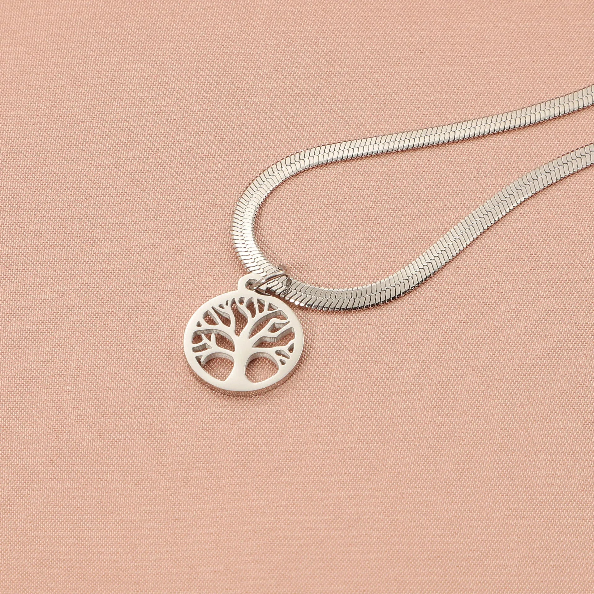 Stainless steel lucky tree pendant necklace on a snake bone chain, shown in gold and steel colour options.