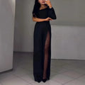 A woman wearing a black oblique shoulder jumpsuit with a high leg slit, made of polyester.