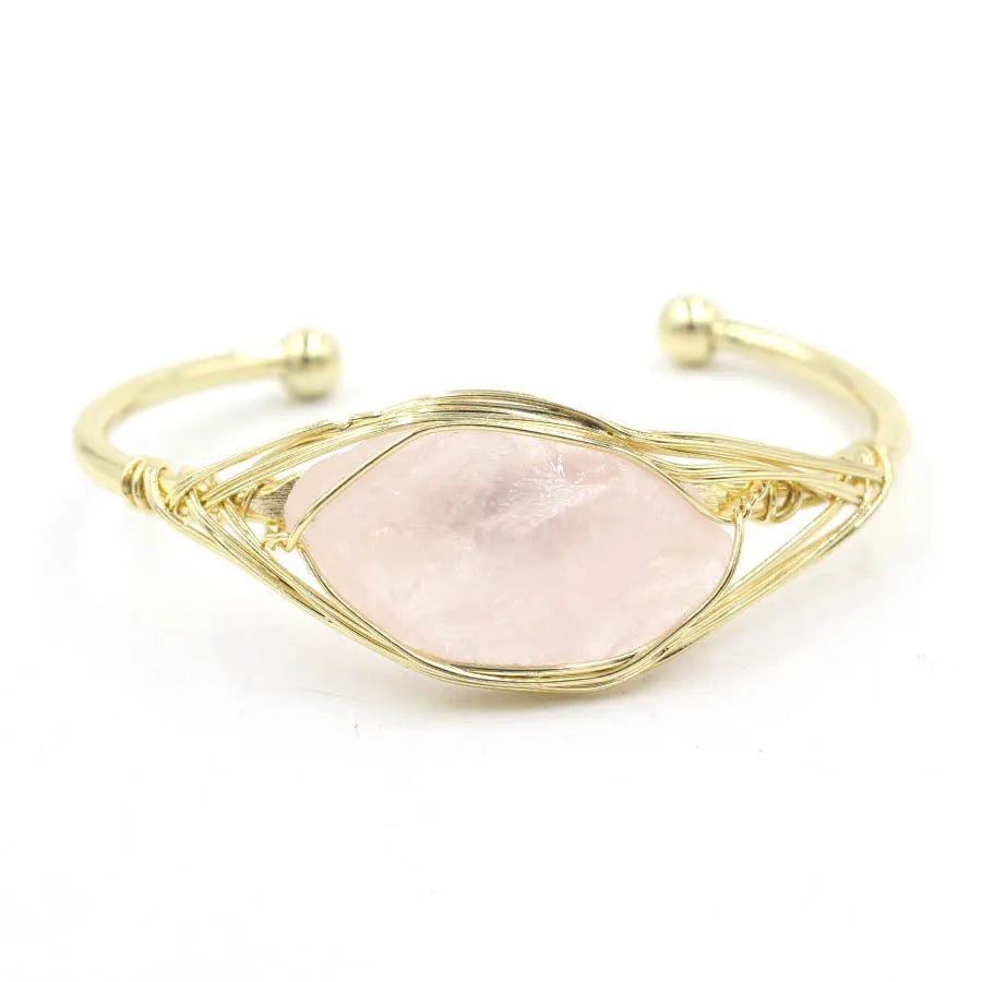 Raw gemstone winding bracelet with 8mm amorphous crystal beads in various colours on a white background.