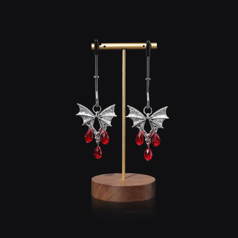 Silver alloy diamond bat nipple clamp set with ruby clip details and adjustable tension mechanism