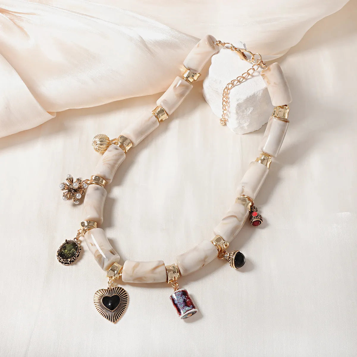 Close-up of a heart-shaped resin and bamboo pendant necklace with an electroplated finish.