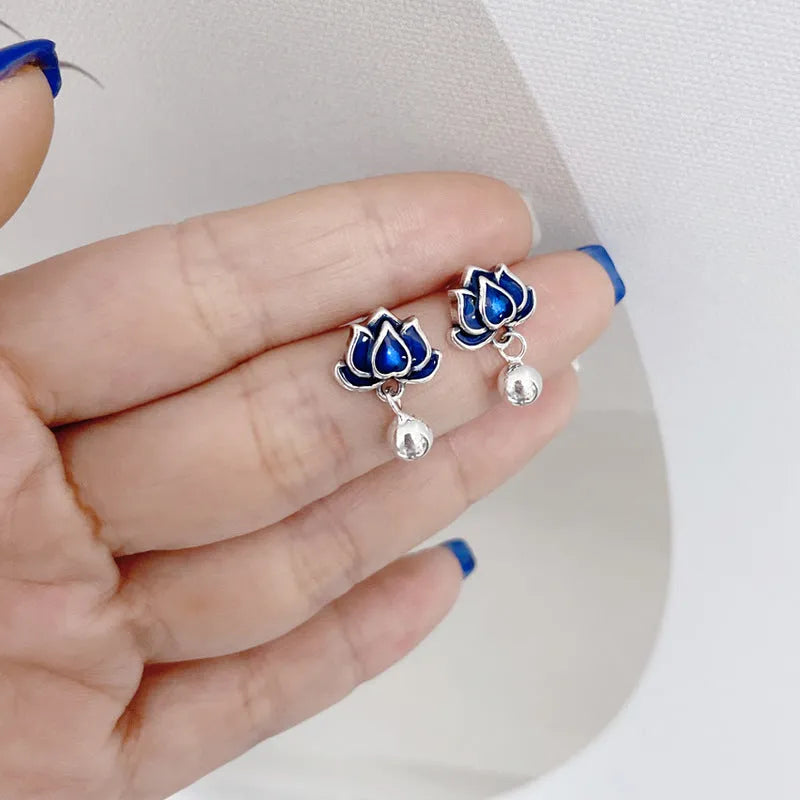A pair of blue alloy lotus ear studs with a retro artistic seedpod and tassel design.