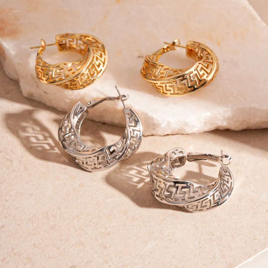 Women's twisted round geometric hollow stud earrings in silver or gold electroplated finish.