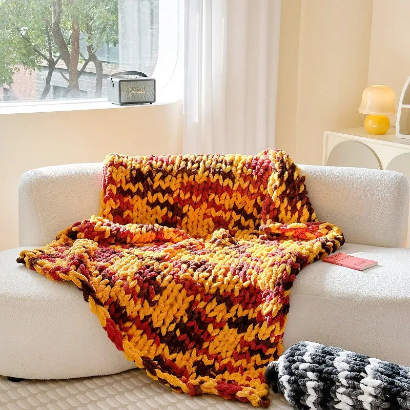 Thick striped chenille handmade blanket in a choice of four colours, shown on a double bed.