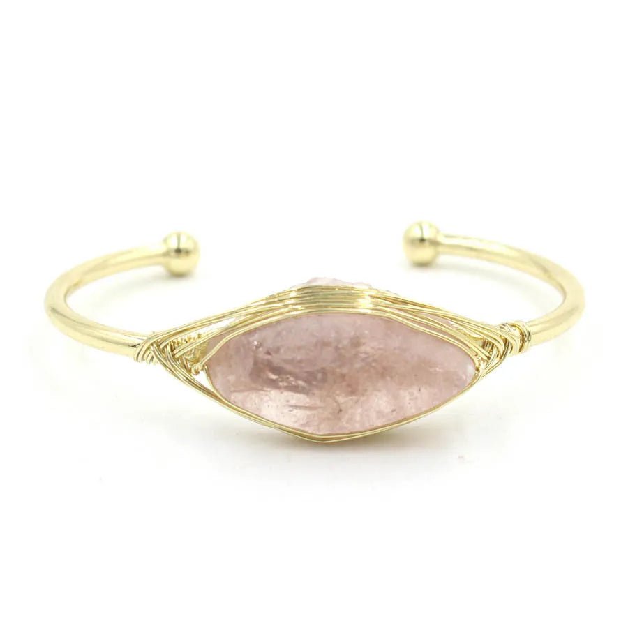 Raw gemstone winding bracelet with 8mm amorphous crystal beads in various colours on a white background.
