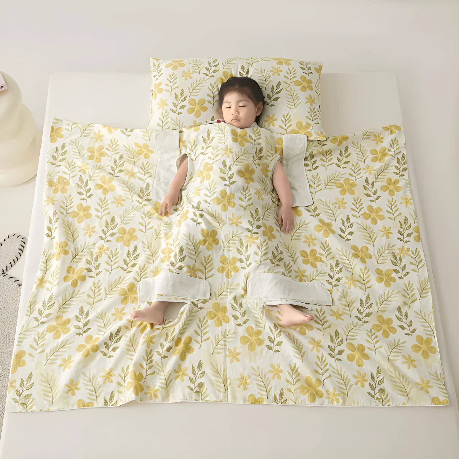 Anti-kick sleeping bag blanket in a colourful Cloud Bear Star Dream design on a bed.