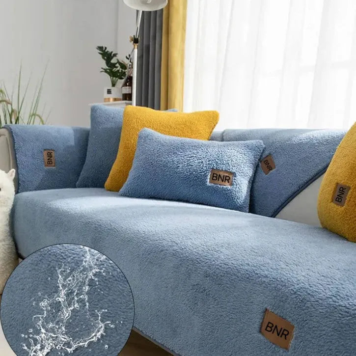 Lambswool solid colour sofa cover in blue, shown on a three-seater sofa.