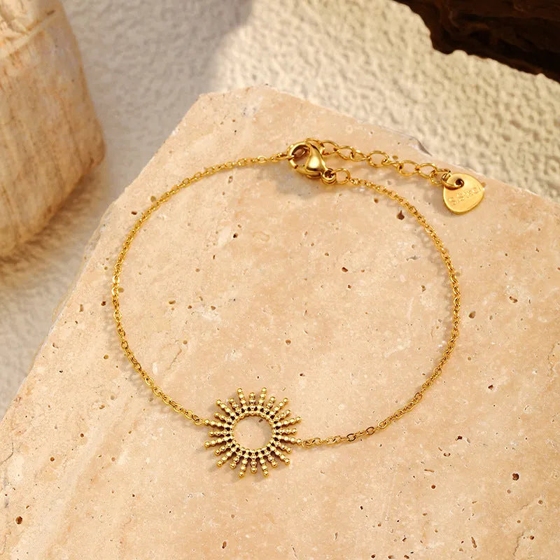 Sunflower jewellery set with gold necklace and bracelet featuring geometric chain design