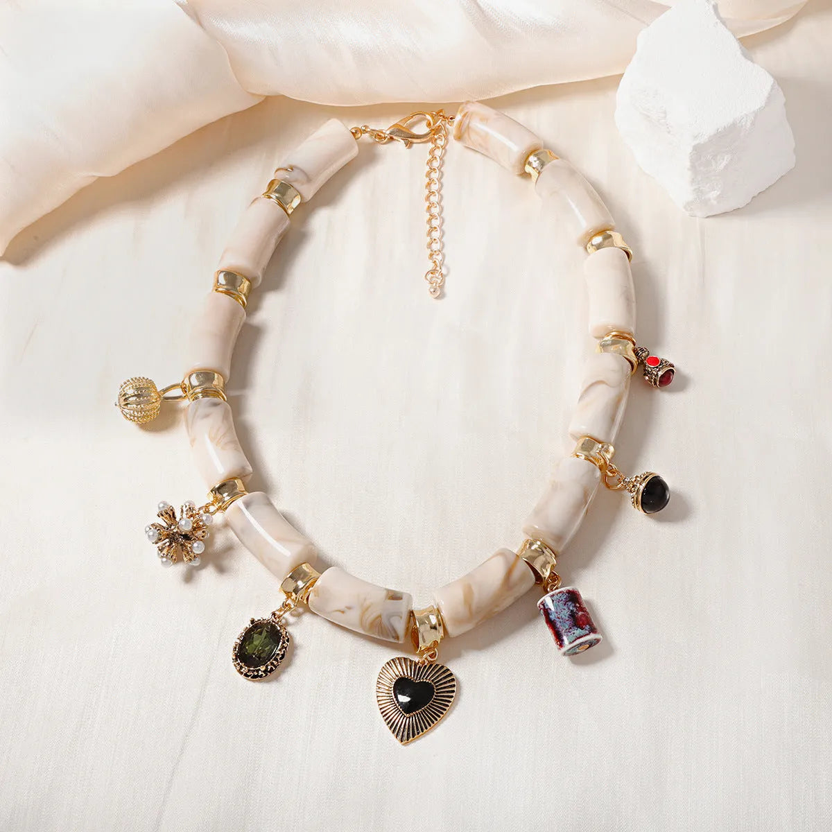 Close-up of a heart-shaped resin and bamboo pendant necklace with an electroplated finish.