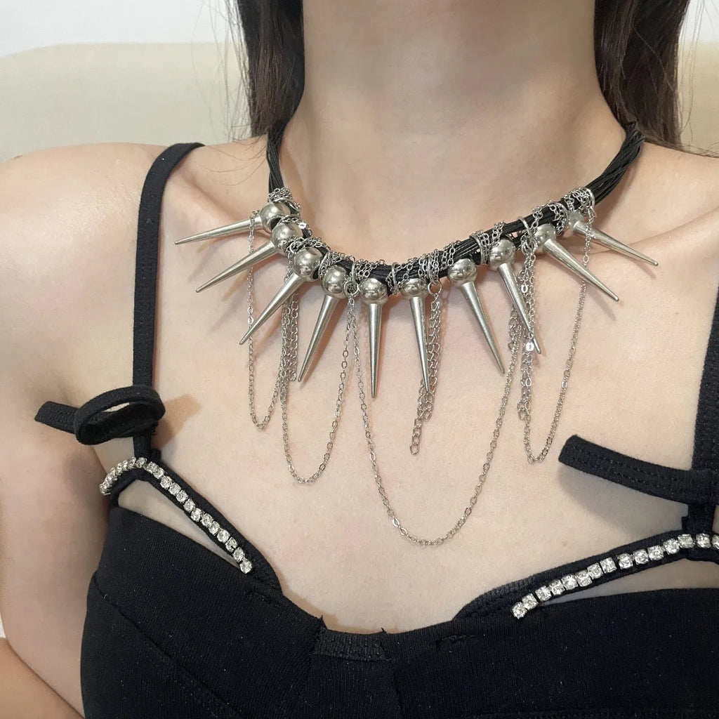 Close-up of a women's casual necklace with leather cord, electroplated round beads, and point rivets in a winding tassel design.