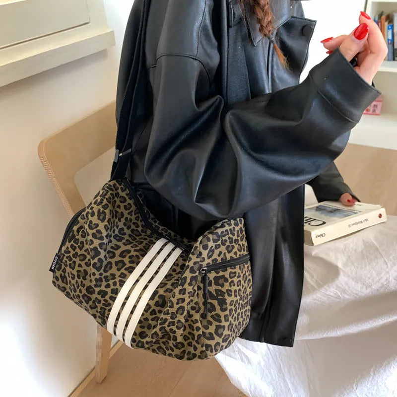 Leopard print sports style shoulder messenger bag with cross-body strap and stitching details