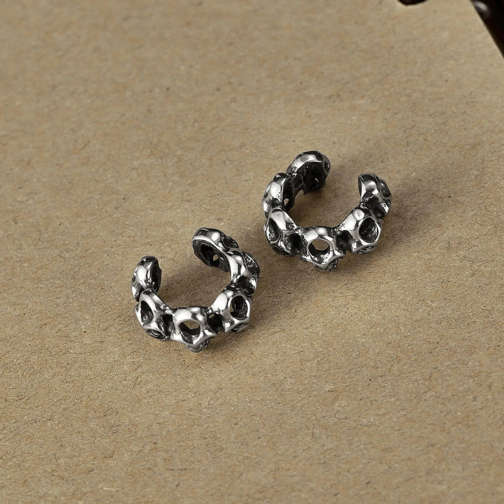 Stainless steel skull ear clip earrings with geometric hollow design and metallic finish