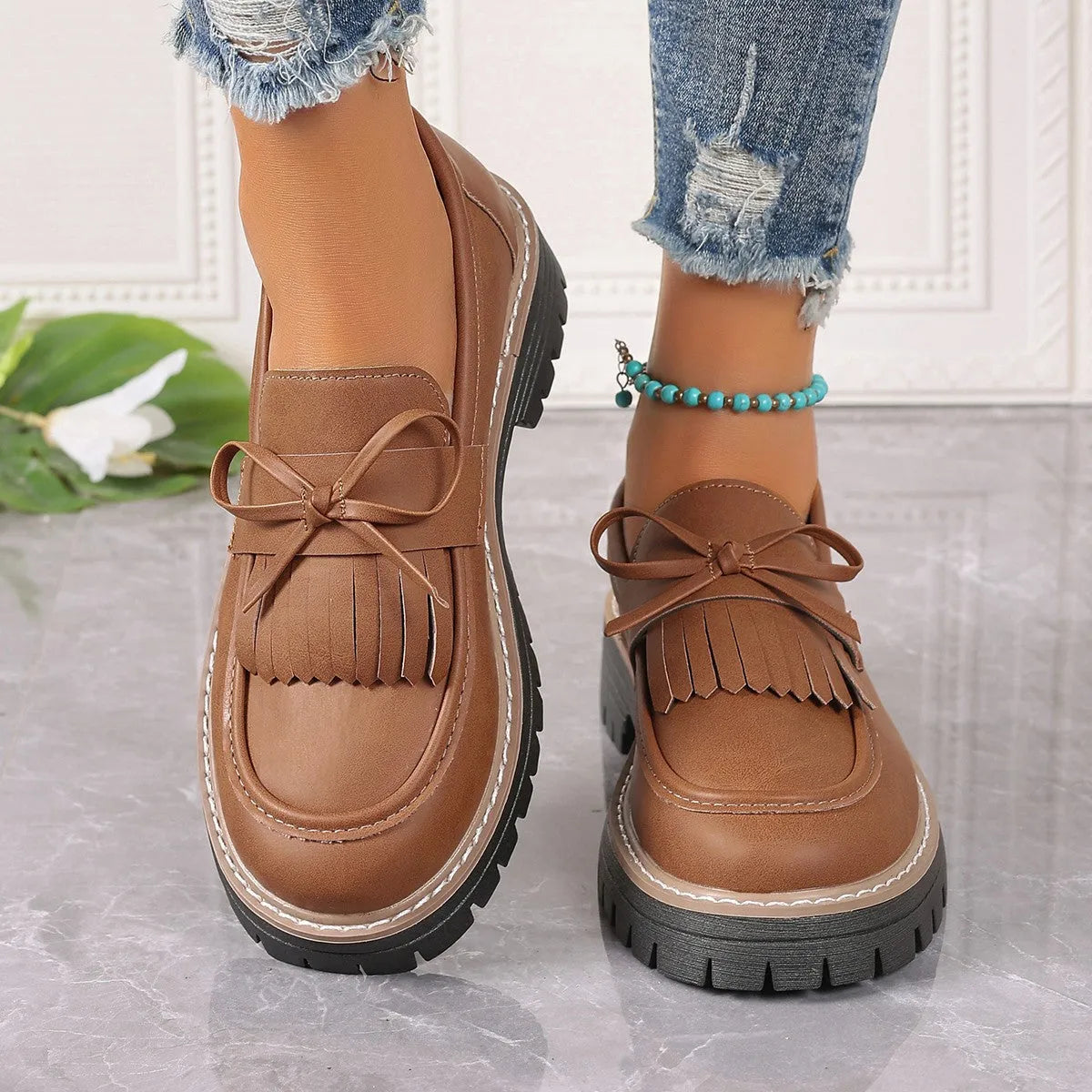 Plus size women's loafers with tassel bowknot detail in black or brown colours with chunky rubber sole