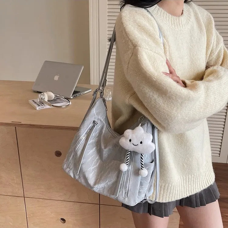 Women's soft PU fashion backpack in black, shown as a multi-functional shoulder bag with a pendant accessory.