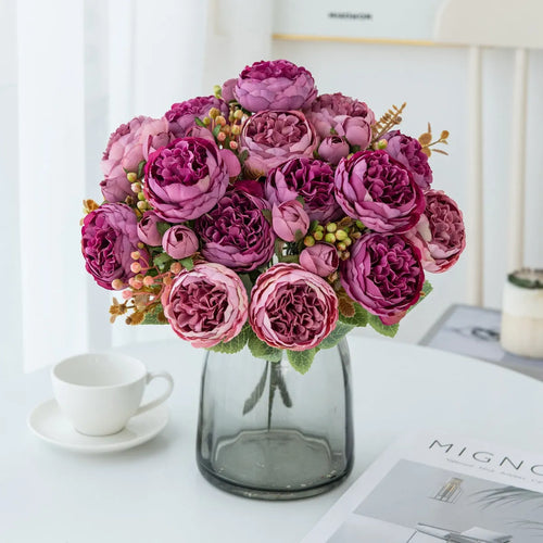 Silk artificial peony bouquet in champagne colour on a table.