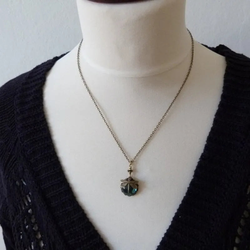 Yellow vintage bronze dragonfly pendant necklace on a silver chain, hand-carved design.