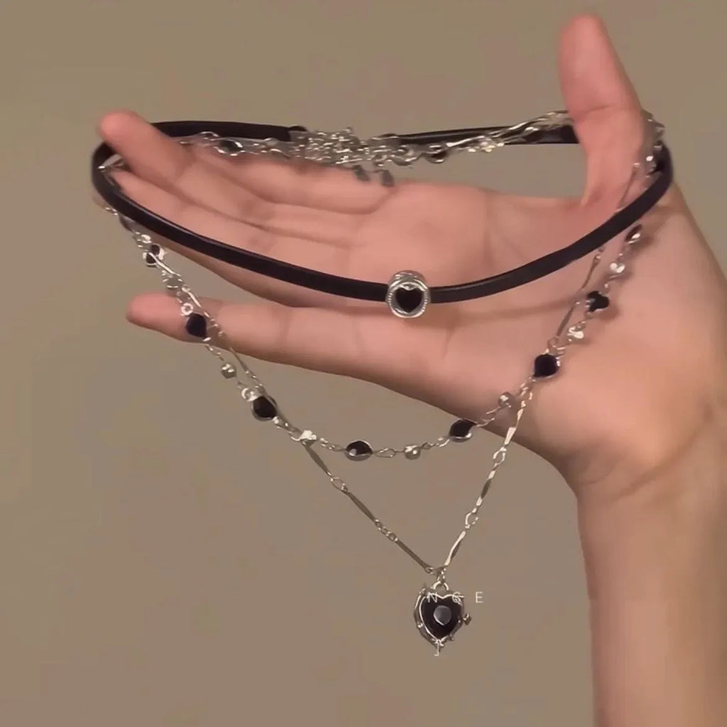 Women's twin necklace set with alloy heart pendants, artificial crystal details, and leather elements on clavicle chains