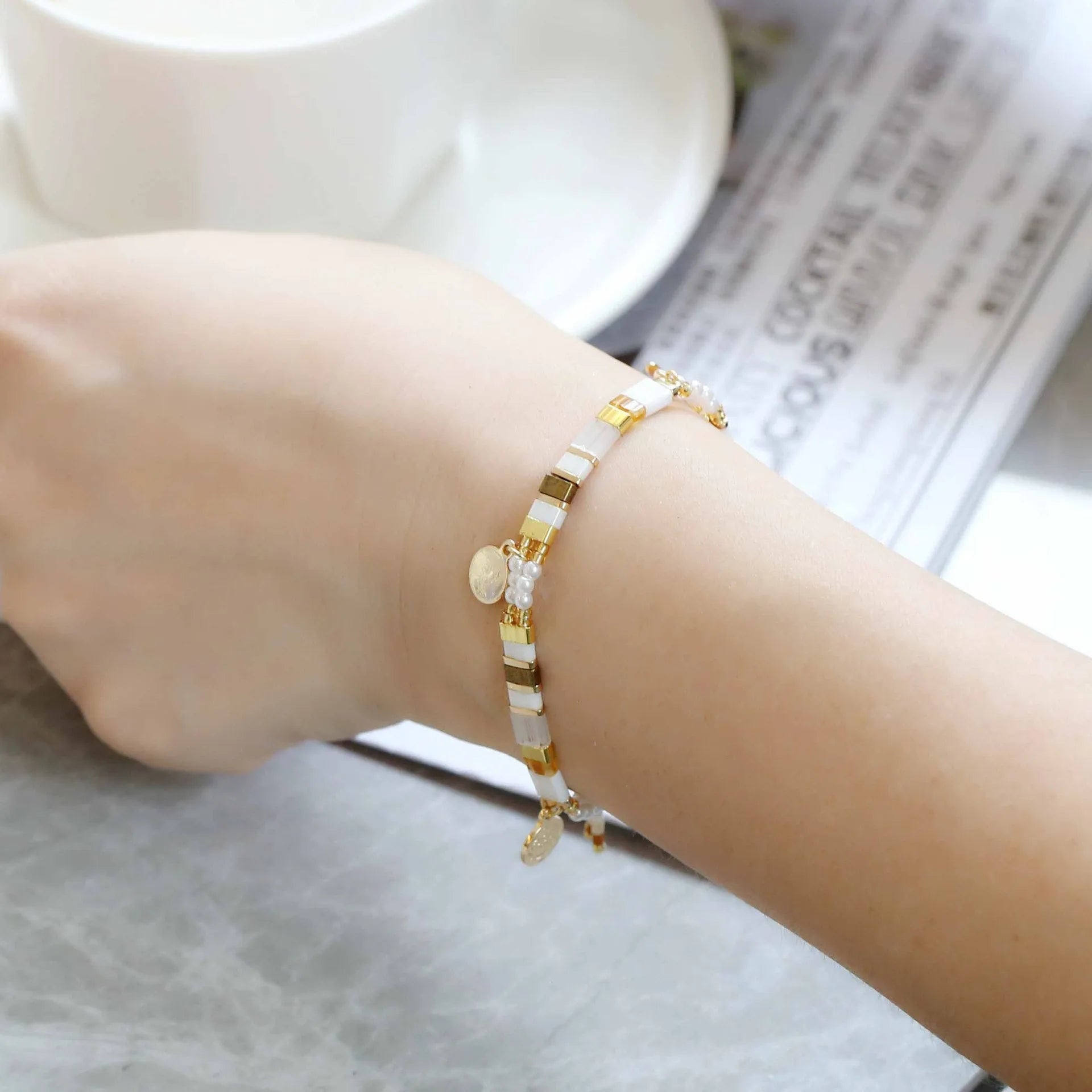 Women's imitation pearl and glass beaded bracelet showing six different colour variations with adjustable closure