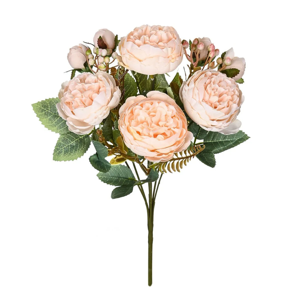 Silk artificial peony bouquet in champagne colour on a table.