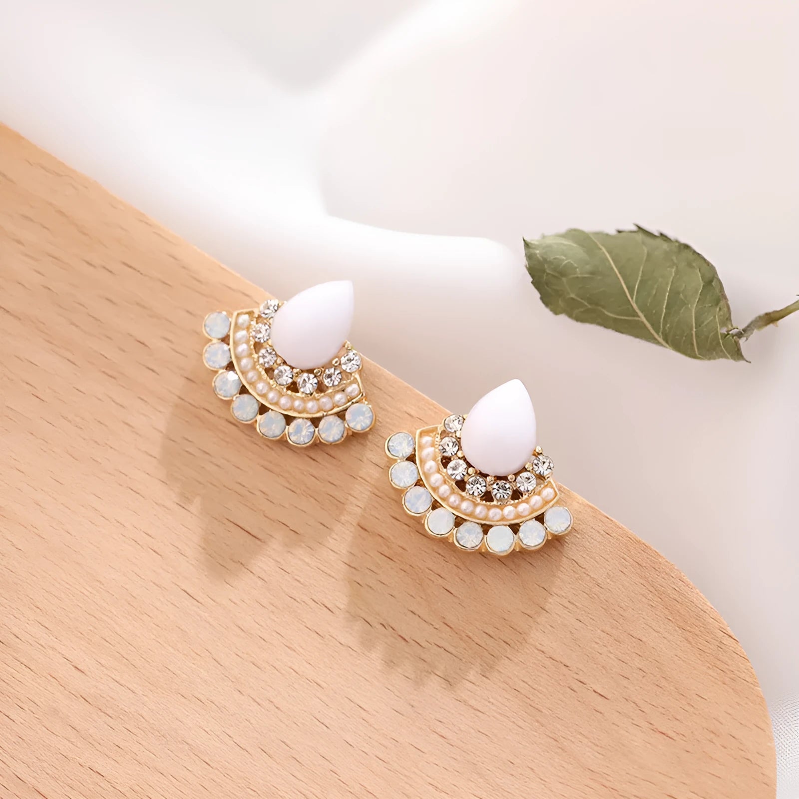 Women's silver geometric fan-shaped drop earrings with a central opal rhinestone.