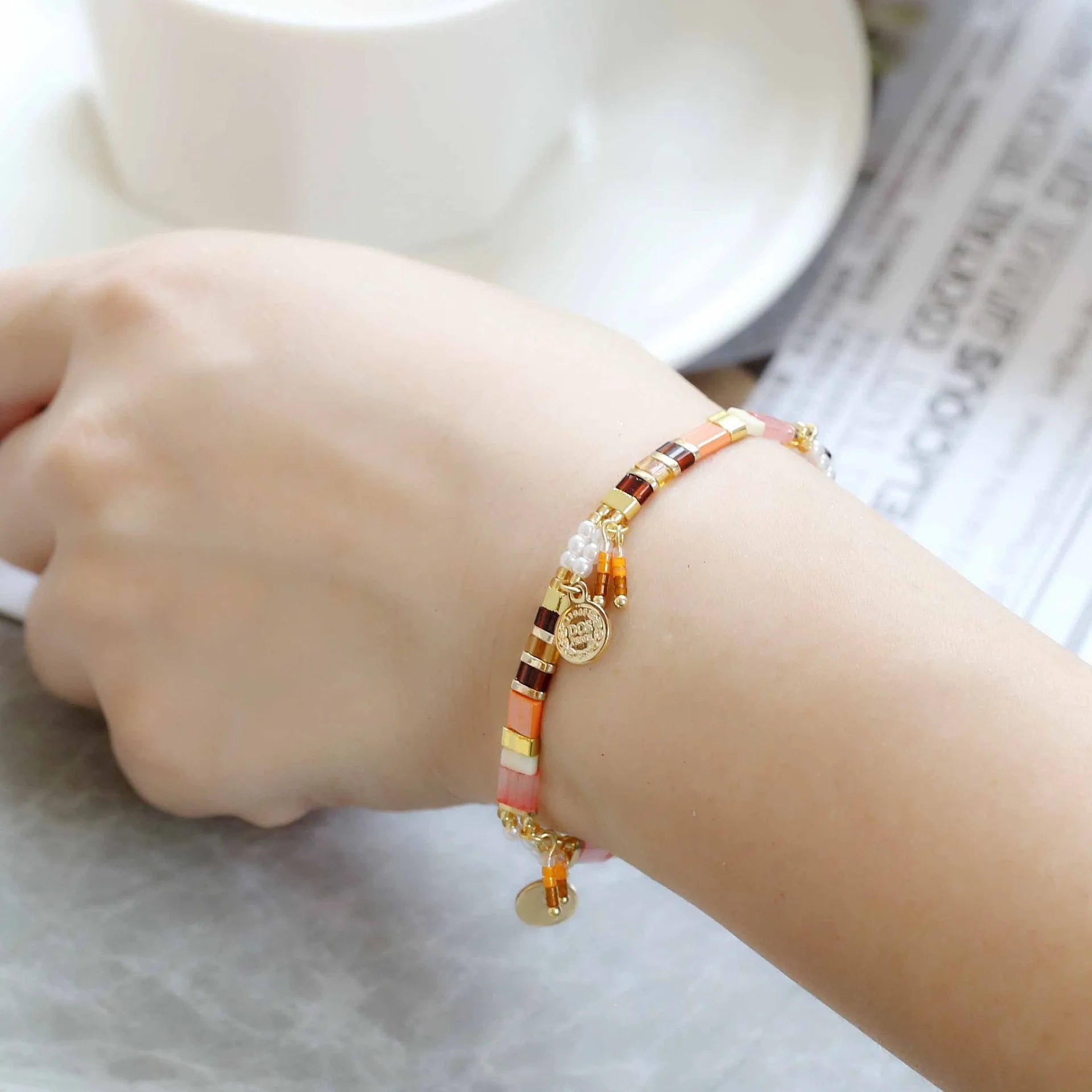 Women's imitation pearl and glass beaded bracelet showing six different colour variations with adjustable closure