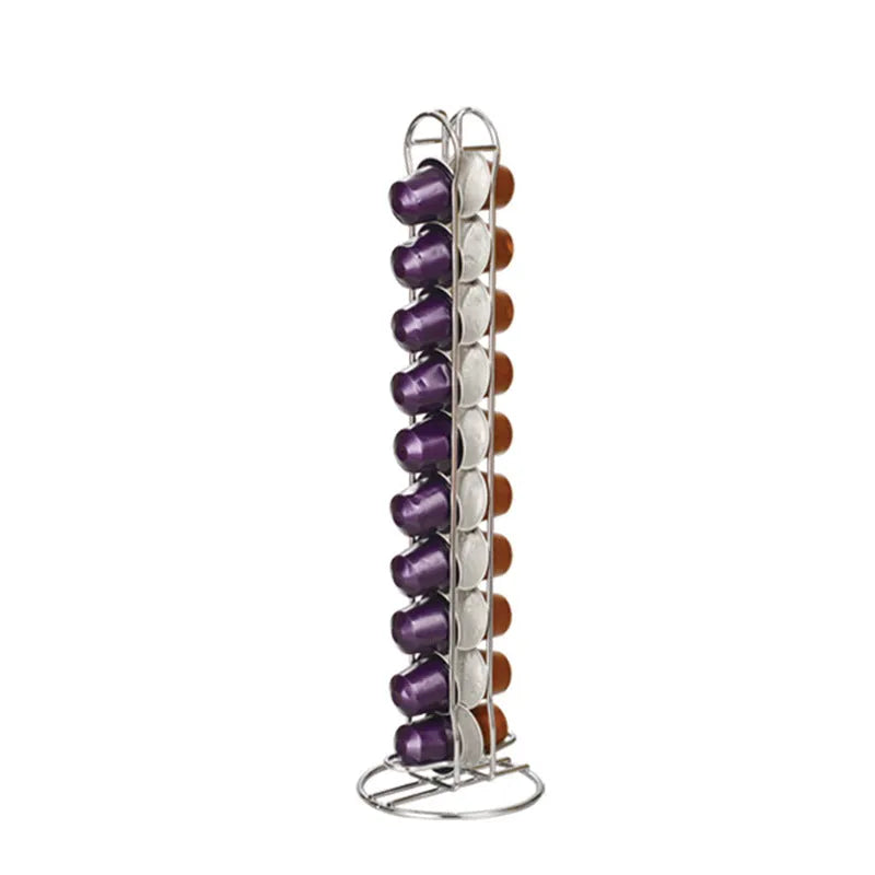 Black wrought iron coffee capsule storage rack holding pods on two shelves.
