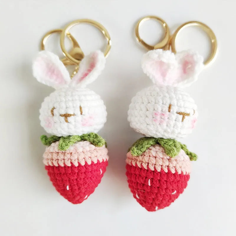 White hand-woven wire pendant with rabbit strawberry cartoon pattern and key attachment.
