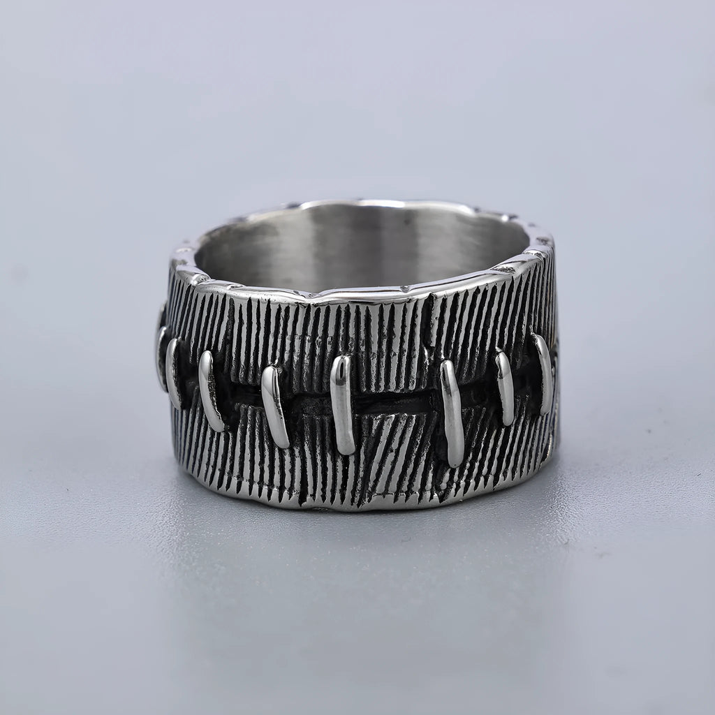 Geometric dark punk titanium steel double ring in retro colour on a black background.