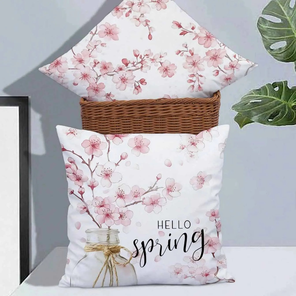 45cm square cherry blossom print cushion cover in short velvet fabric on a grey sofa.