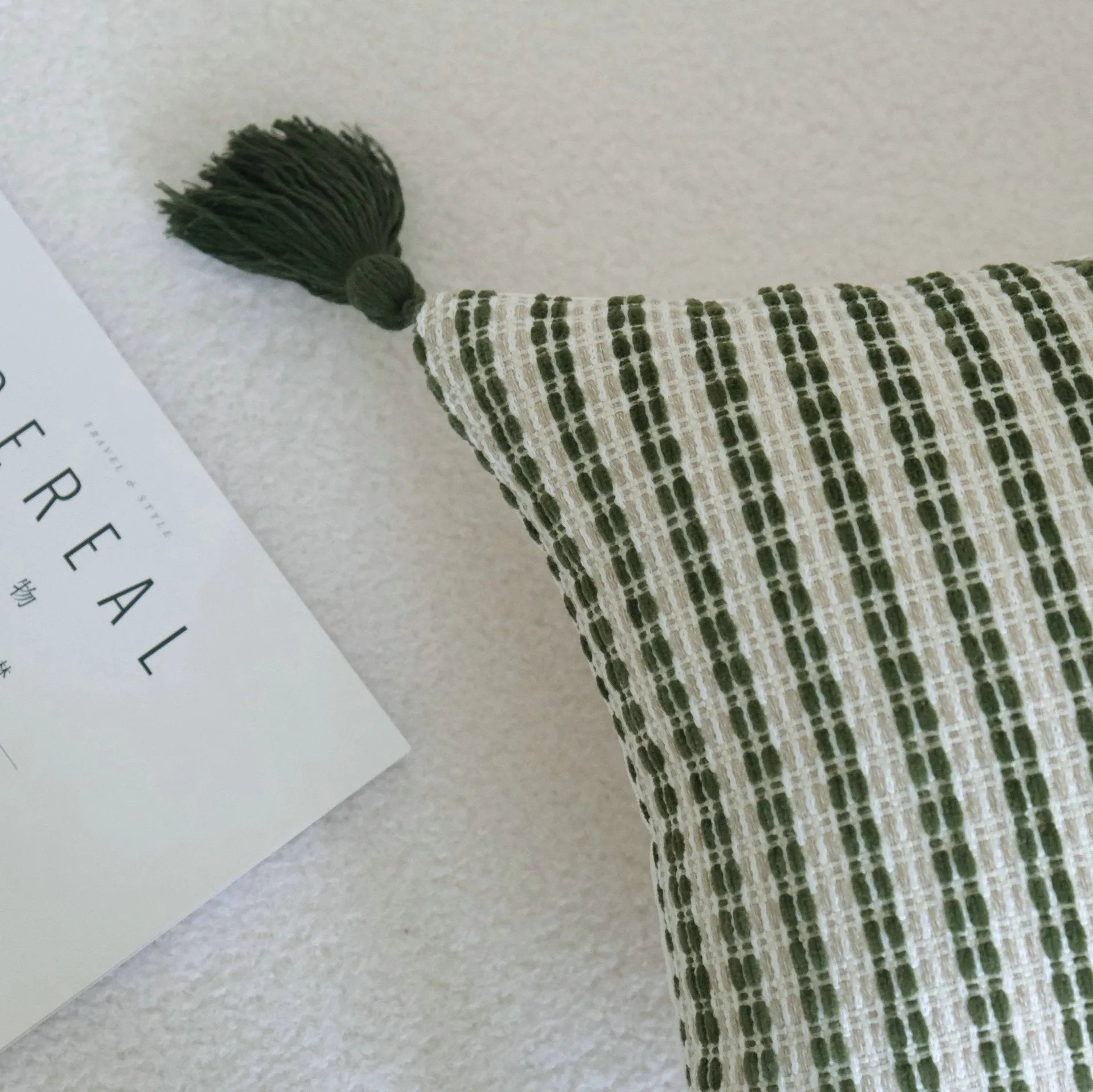 Green cotton linen hotel sample pillow with tassel detail in striped or leaf patterns