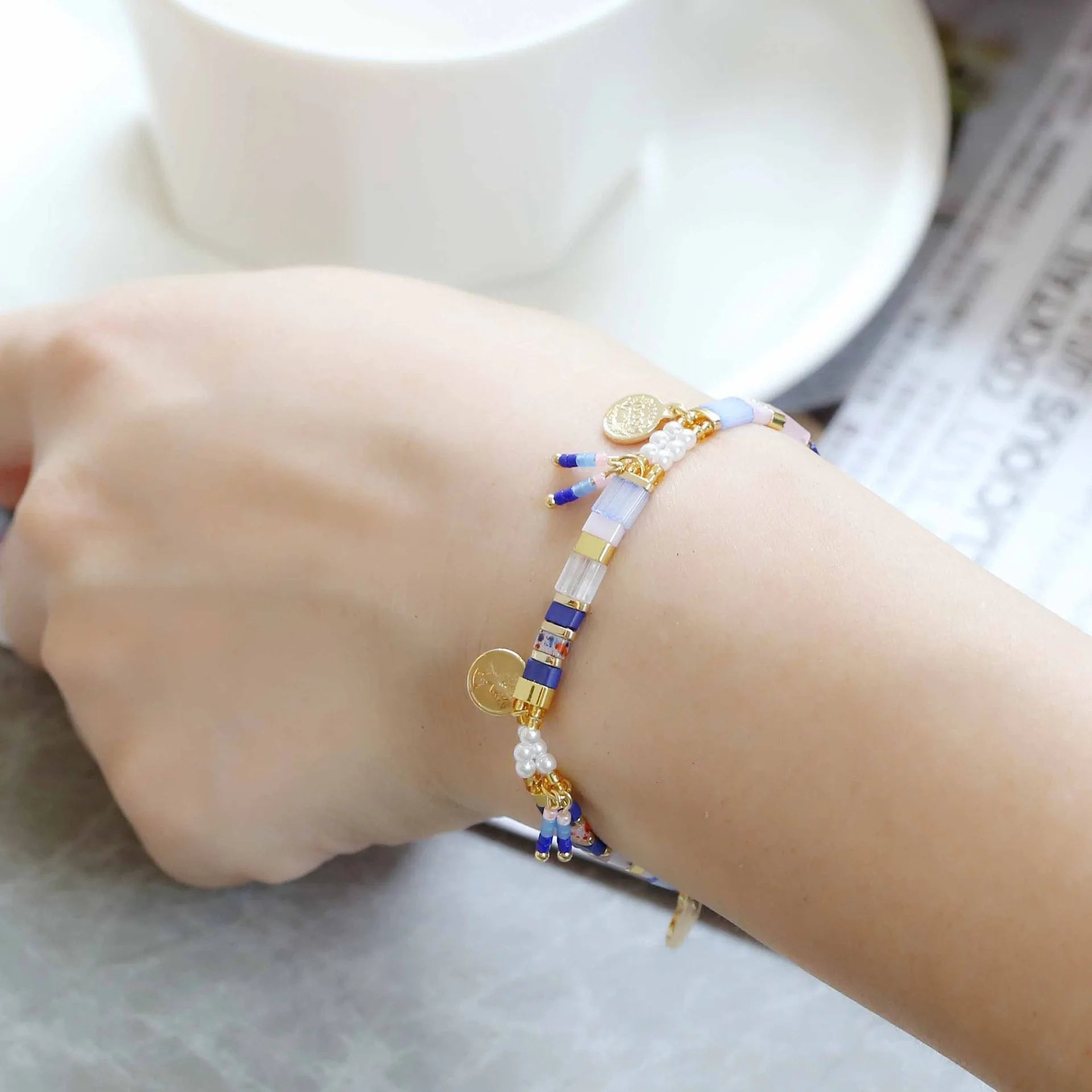 Women's imitation pearl and glass beaded bracelet showing six different colour variations with adjustable closure