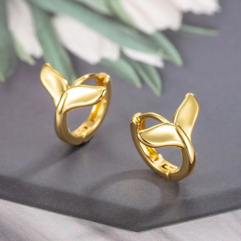 A pair of women's simple fishtail design earrings with an electroplated finish in white gold or yellow gold colour.