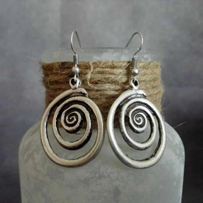 Retro geometric spiral distressed silver alloy earrings showing textured finish and spiral shape