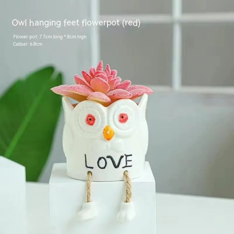 Cartoon style ceramic hanging foot flowerpot for succulent plants on a desktop.