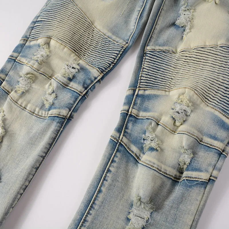 Men's light blue slim fit distressed jeans with hand-frayed details on a mid-waist, straight leg cut.