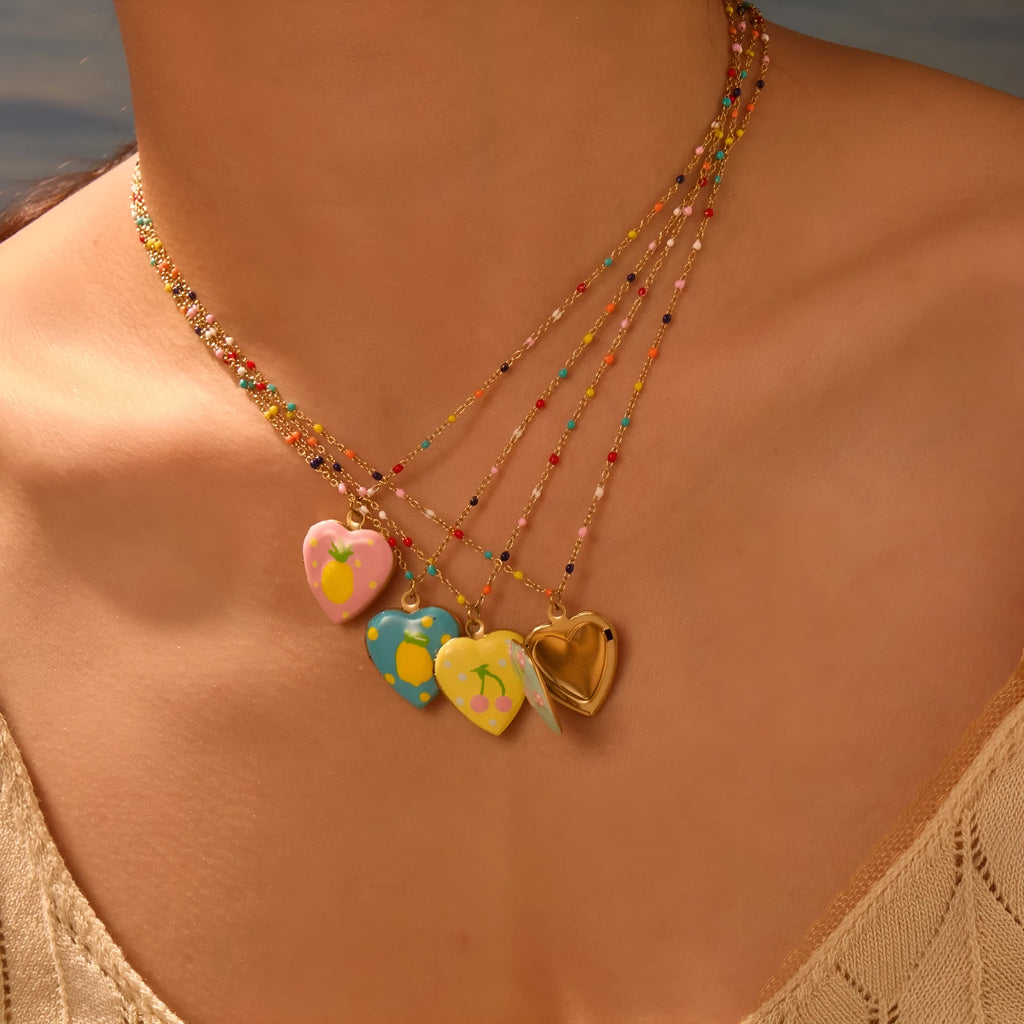 Women's stainless steel necklace with 18K gold plating showing heart pendant with fruit designs