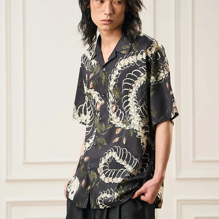 Short sleeve loose fit shirt with snake bone and floral pattern print and a Cuban collar.