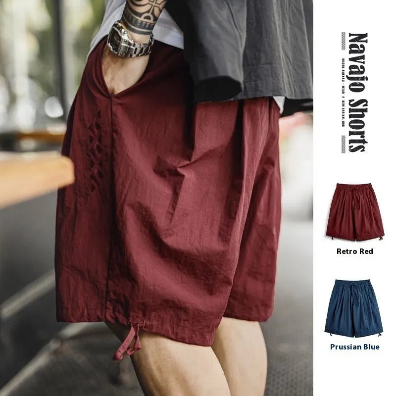 Men's Prussian blue nylon shorts with embroidered design and loose fit