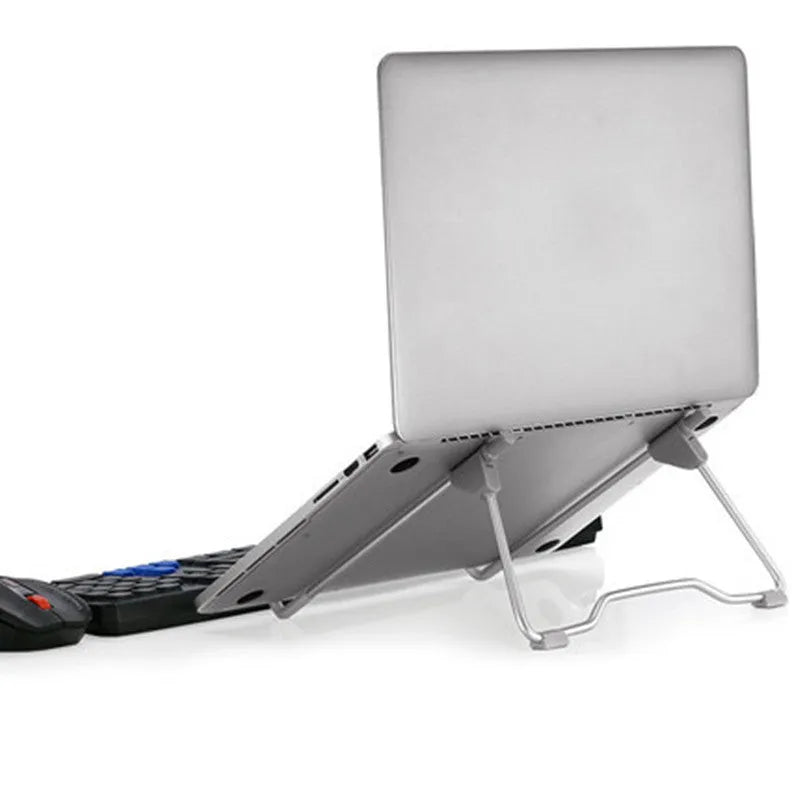 Grey aluminium alloy and plastic adjustable stand holding a mobile phone and a laptop.