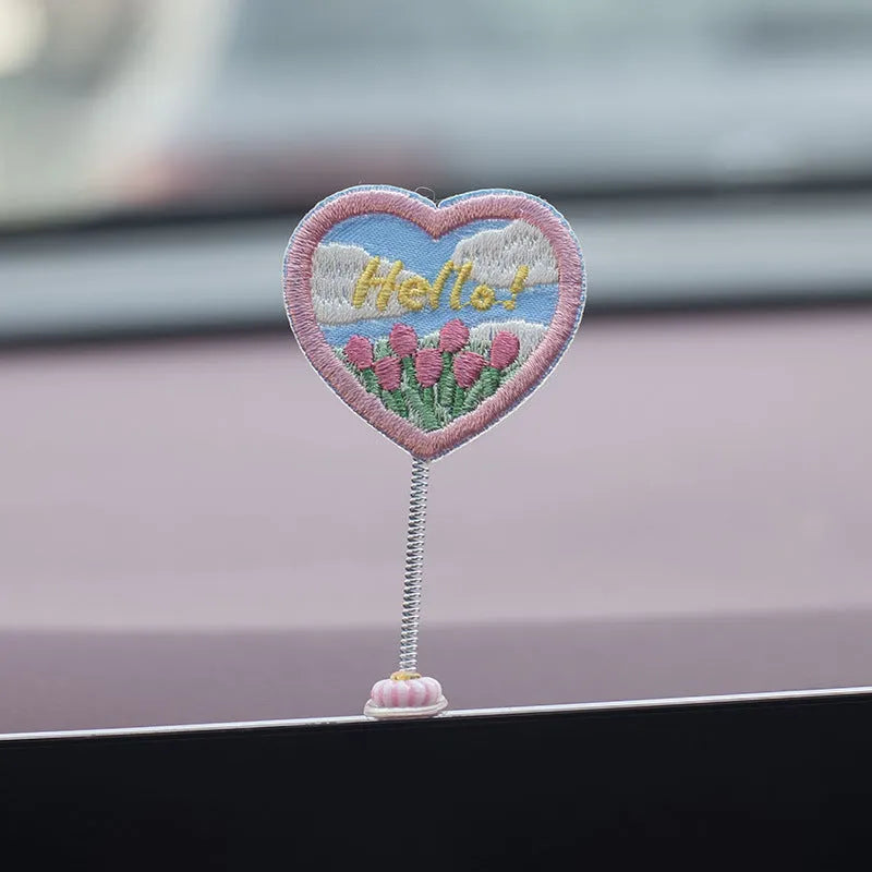 PVC cartoon duckling car decoration set with six small ducks and one Hello sign on a dashboard.